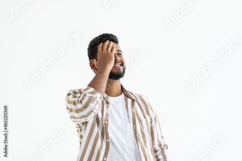 Young indian man over isolated white background suffering from headache desperate and stressed because pain and migraine. Hands on head.