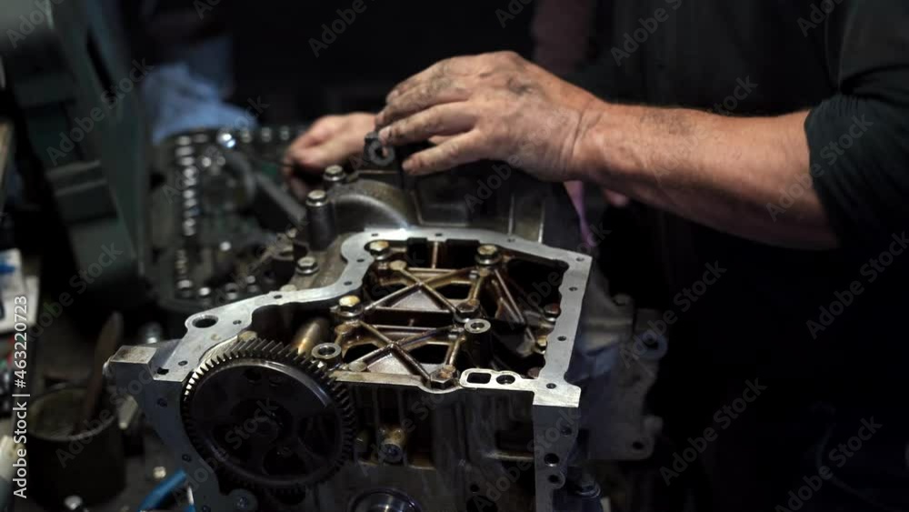 Close up video of unrecognizable mechanic assembles Car engine with tool Close up video of unrecognizable mechanic assembles Car engine with tool