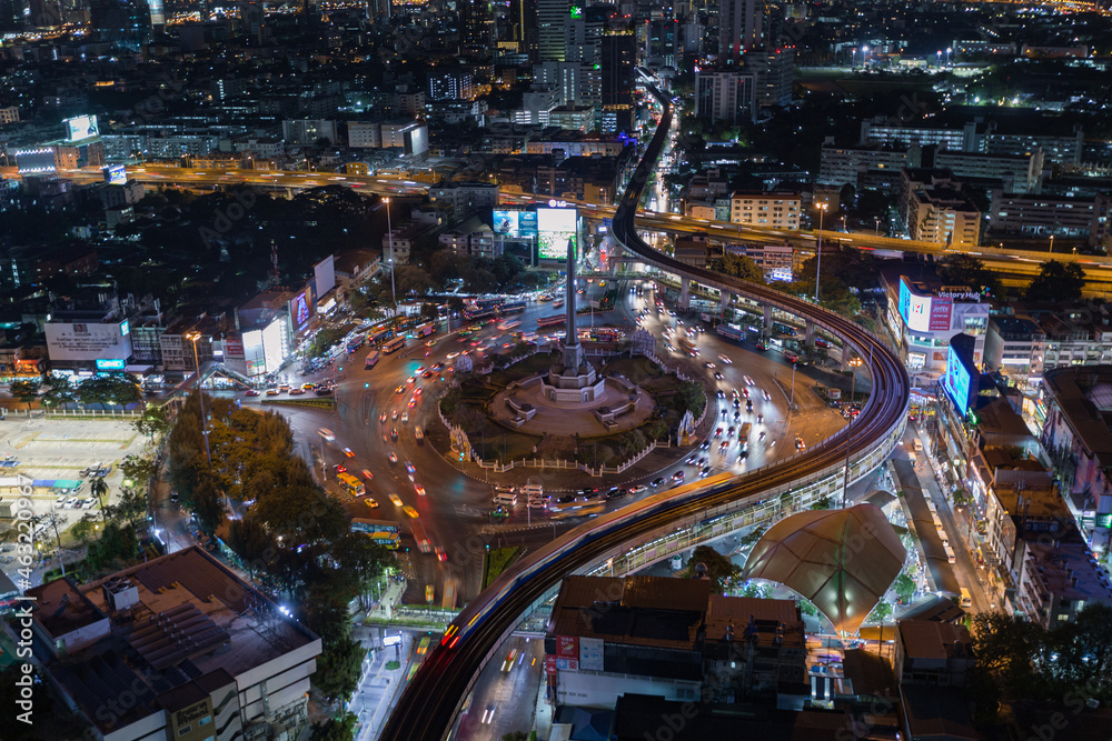 aerial view of highway junctions with roundabout. Bridge roads shape circle in structure of architecture and transportation concept. Top view. Urban city, Bangkok at sunset, Thailand.