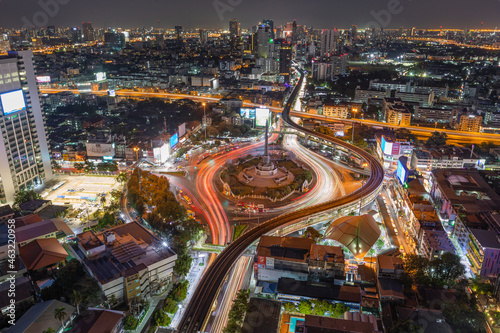 aerial view of highway junctions with roundabout. Bridge roads shape circle in structure of architecture and transportation concept. Top view. Urban city, Bangkok at sunset, Thailand.