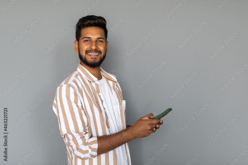 Portrait of indian young man using phone on white background Portrait of indian young man using phone on white background