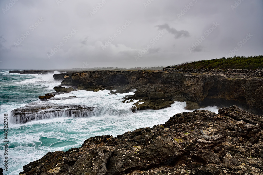 Rough ocean waves crashing against the rocky cliffs of North Point, Barbados, Caribbean