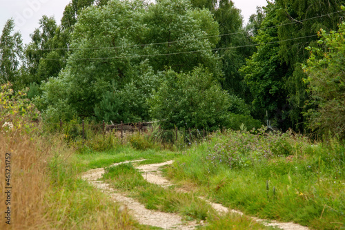dirt road with a small stone in the village