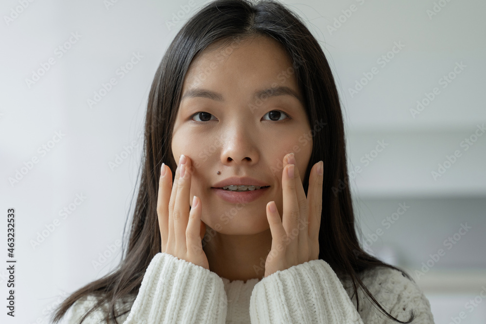 Beautiful woman touching her face by hands. Asian woman looking at the mirror with the trouble on her skin. Beautiful woman touching her face by hands. Asian woman looking at the mirror with the trouble on her skin.