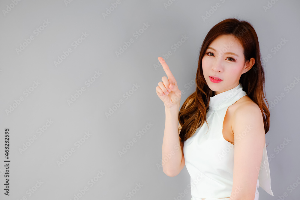 Portrait beautiful asian woman on gray background, emotions action Portrait beautiful asian woman on gray background, emotions action