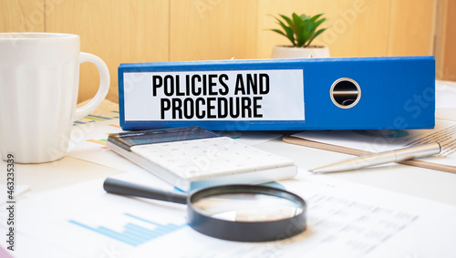 Policies and Procedure words on labels with document binders