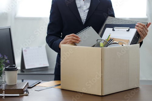 Resignation concept.Businesswoman packing personal company belongings when she deciding resignation change of job or fired from the company. photo