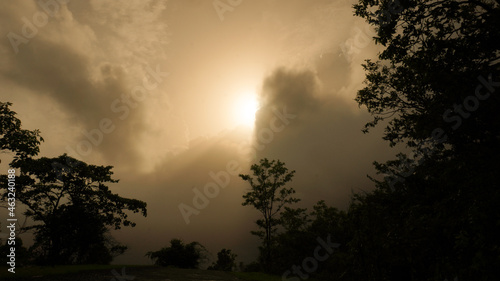 Beautiful sunset behind and silhouette of forest