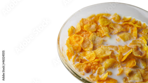 A bowl of a corn flakes in the milk on the white background.