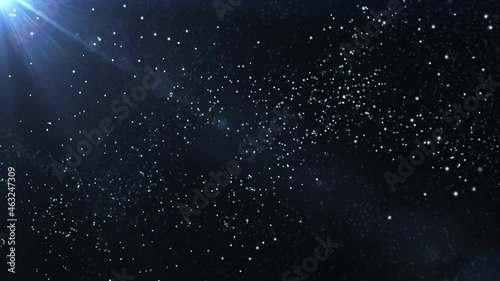 Slowly floating dust particles in the dark in the rays of light