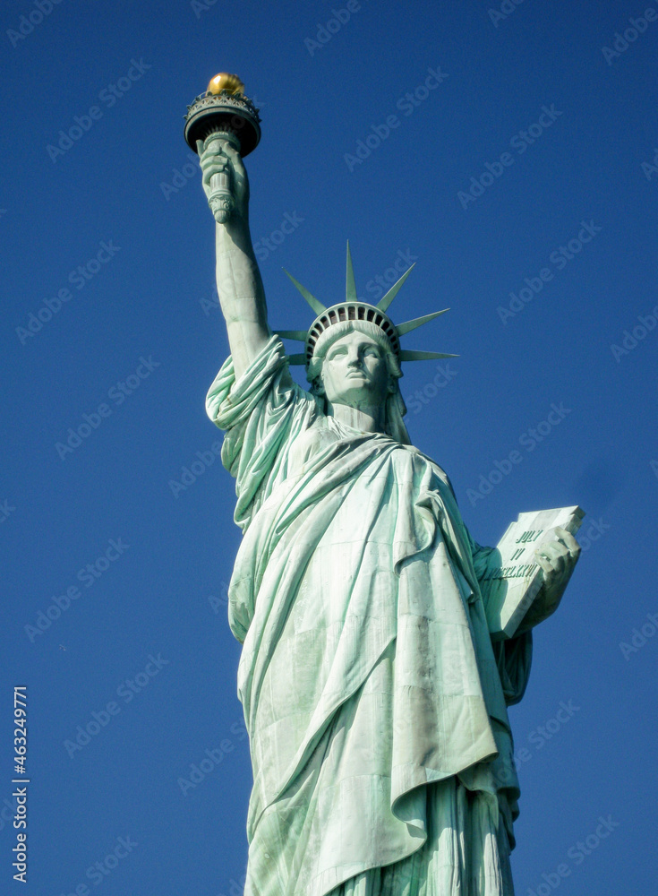 Fototapeta premium Statue of Liberty in New York isolated against a deep blue sky. No people. Copy space.
