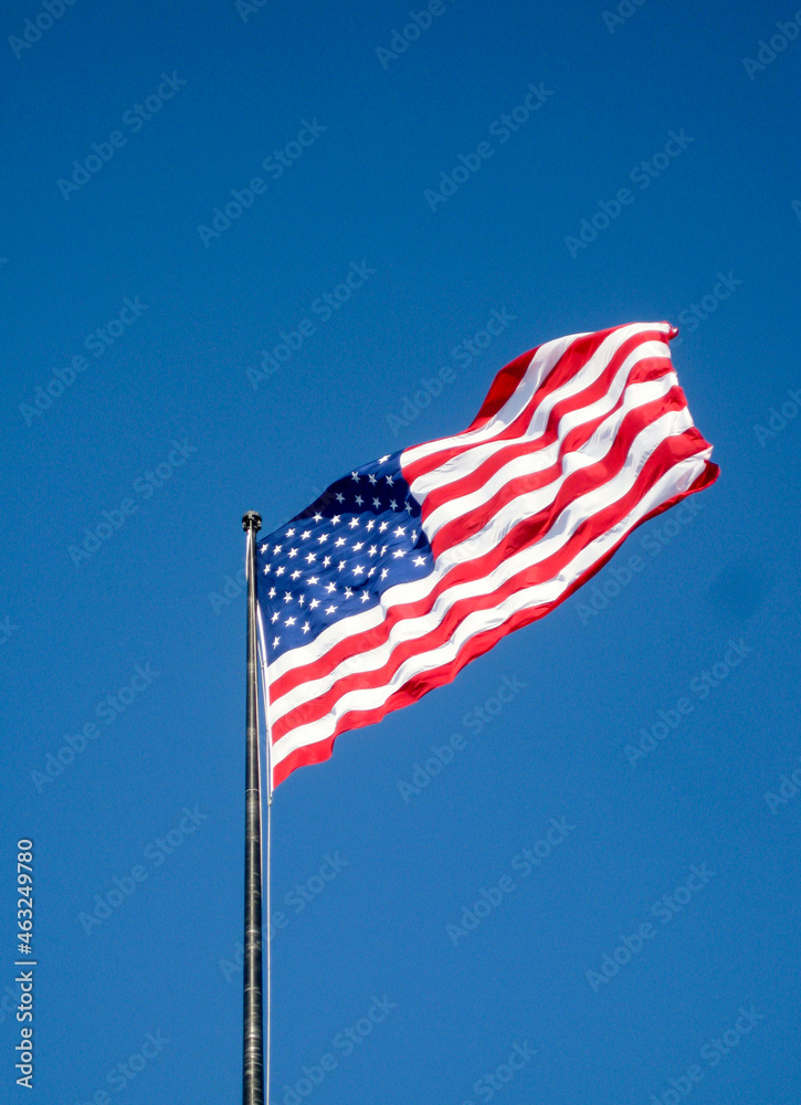 American flag, the Stars and Stripes, isolated against a deep blue sky