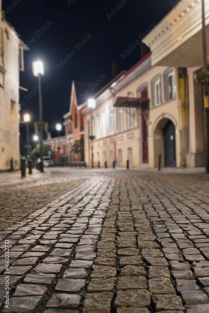  Night view of a cobblestone street in old district, selective focus