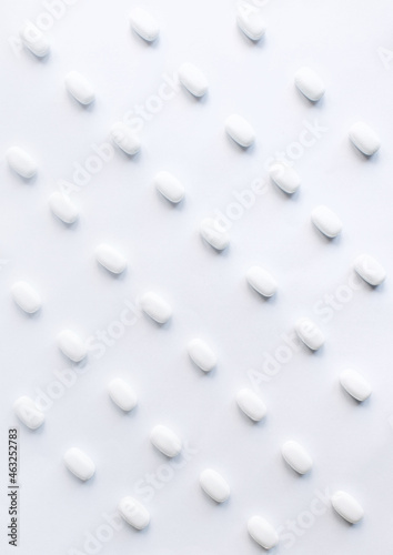 Many white pills on a white background. Health. © Olena Svechkova