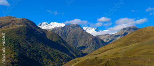 Mountain landscape with snow-capped peaks against the blue sky