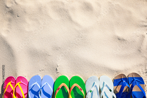 Stylish flip flops on beach, flat lay. Space for text photo