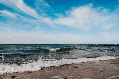 фотография baltic sea coast on a sunny day, blue sky and strong waves