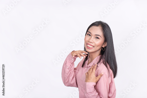 A demure young asian smiling for the camera. Isolated on white background. photo
