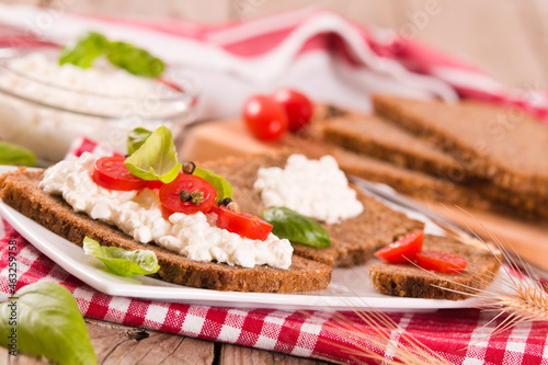 Rye bread with cottage cheese and cherries.