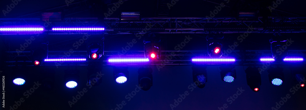 Blue-pink spotlights at a concert at night.