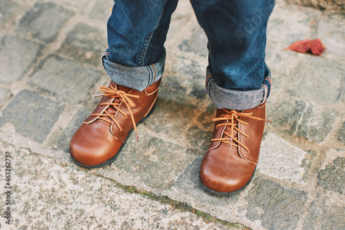 Close up image of brown leather vintage shoes wearing by a child