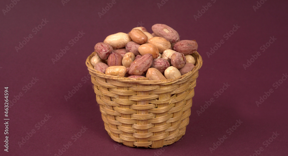 Groundnuts in wooden bowl isolated on plane background, salted roasted peeled nuts, top view Groundnuts in wooden bowl isolated on plane background, salted roasted peeled nuts, top view