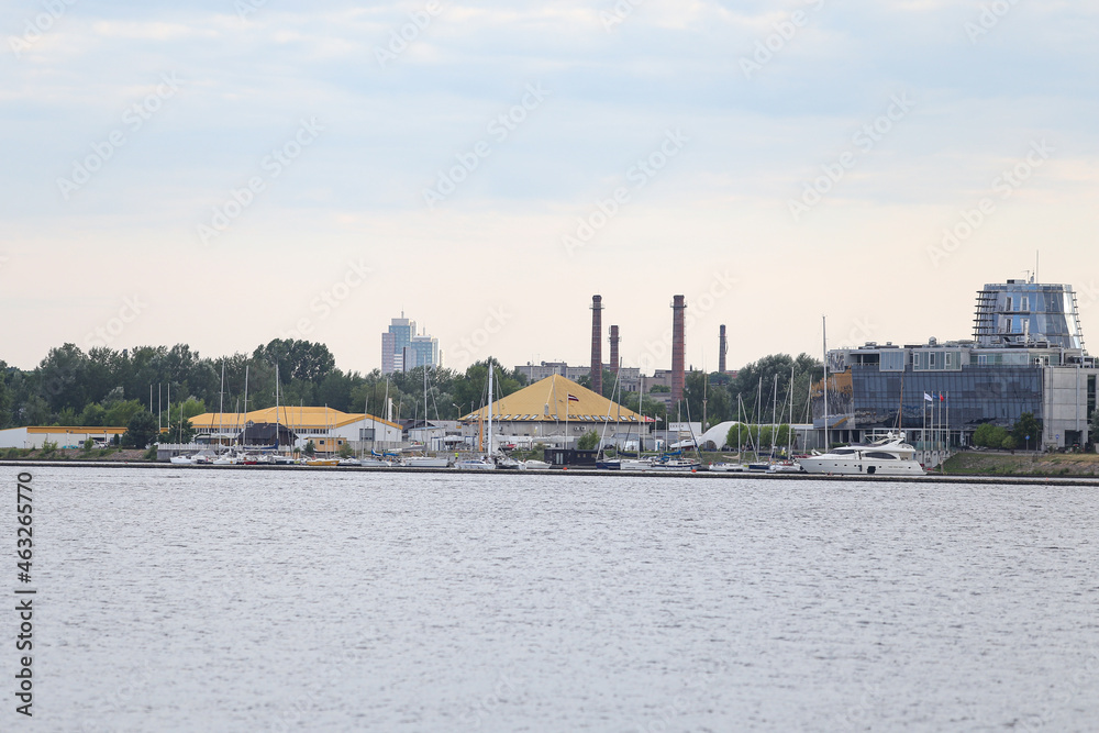 Industrial riverside view of commercial buildings and boating pier.