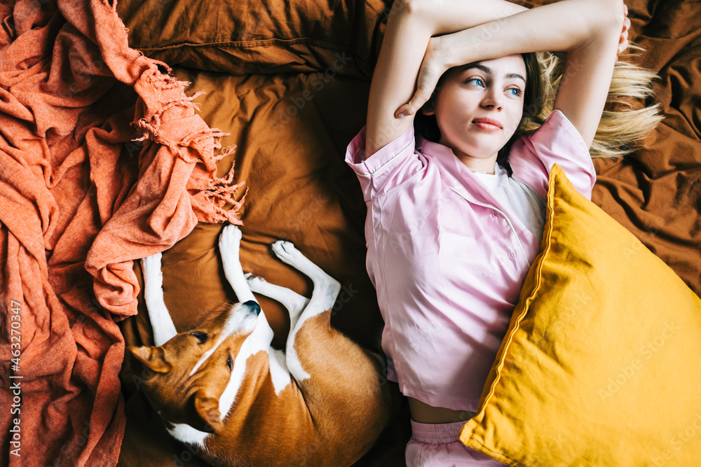 Young caucasian thoughtful woman waking up with pet in the morning. Young caucasian thoughtful woman waking up with pet in the morning.
