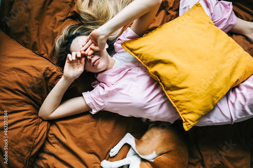 Obraz na plátně Young caucasian woman waking up alone in the morning.