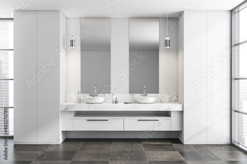 Bright bathroom interior with double sinks  two mirrors  panoramic window