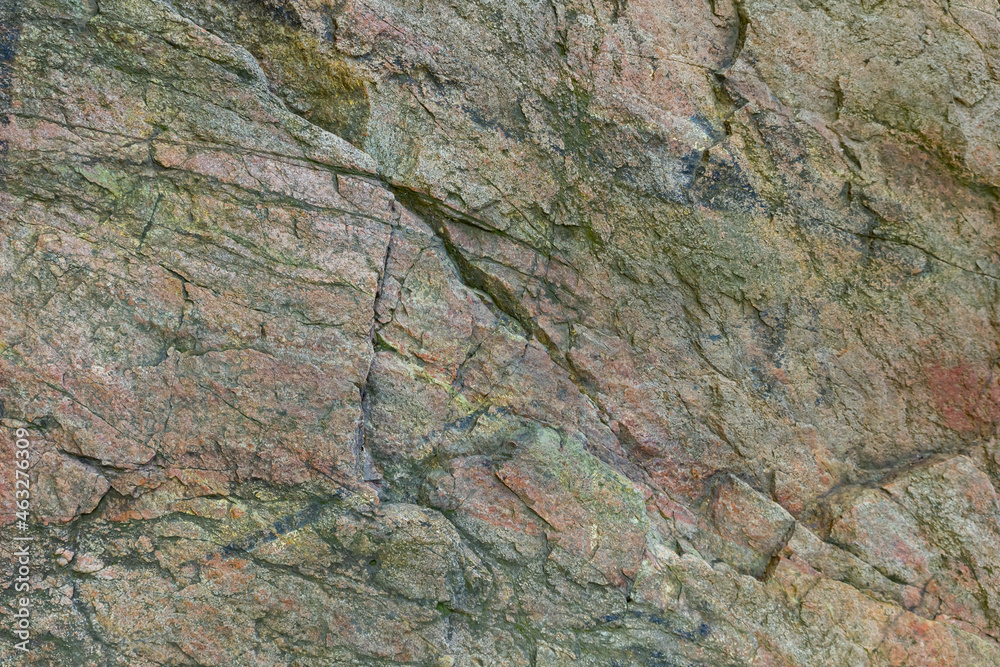 Cracked granite stone texture. Solid rock close-up. Weathered rock Cracked granite stone texture. Solid rock close-up. Weathered rock