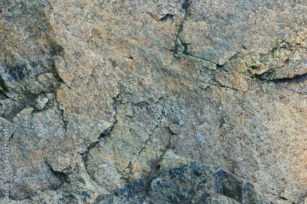 Cracked granite stone texture. Solid rock close-up. Weathered rock Cracked granite stone texture. Solid rock close-up. Weathered rock