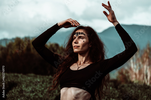 Beautiful young woman on background of greenery. Boho style. Forest nymph.