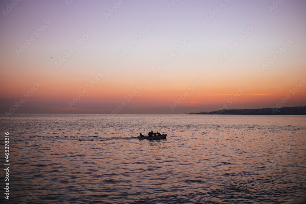 small boat on the sea at sunset