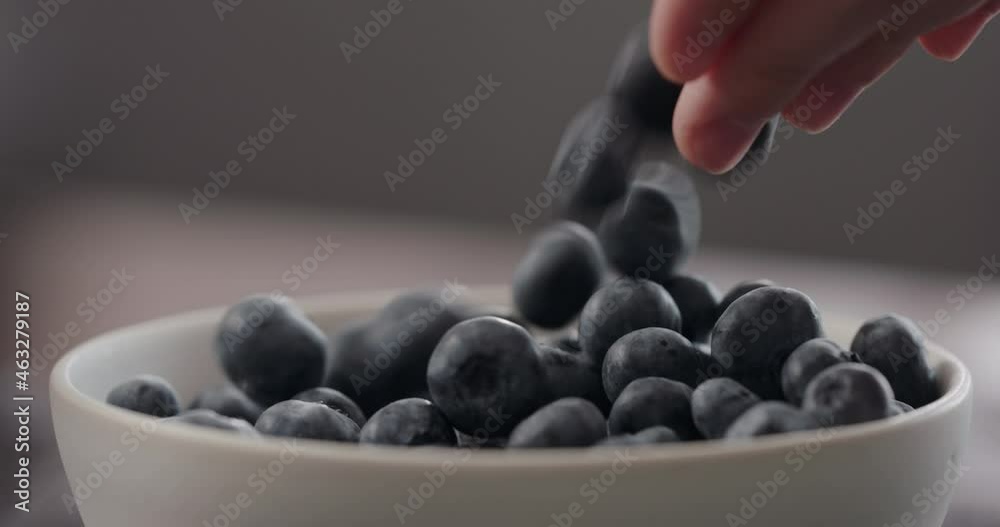Slow motion man take ripe blueberries from white bowl closeup Slow motion man take ripe blueberries from white bowl closeup