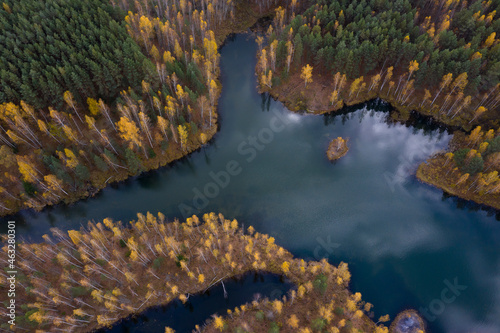 Aerial view of small lakes surrounded by autumn forest.