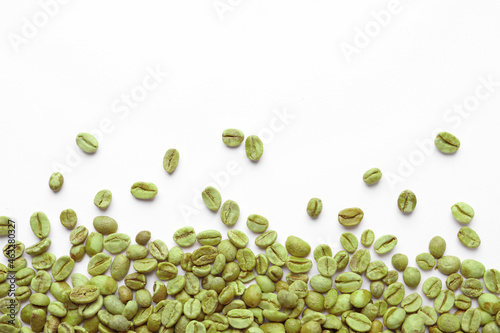 Many green coffee beans on white background, top view