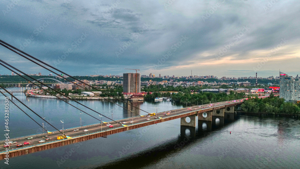Beautiful aerial drone view of the North bridge in Kiev (Ukraine), sunset and cityscape of Kiev.
