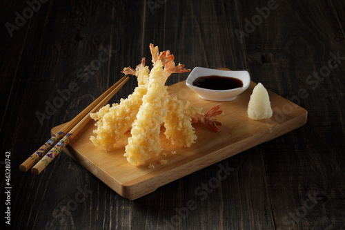 Deep fried Shrimp Tempura,traditional japanese food on a wooden board on dark wooden background.