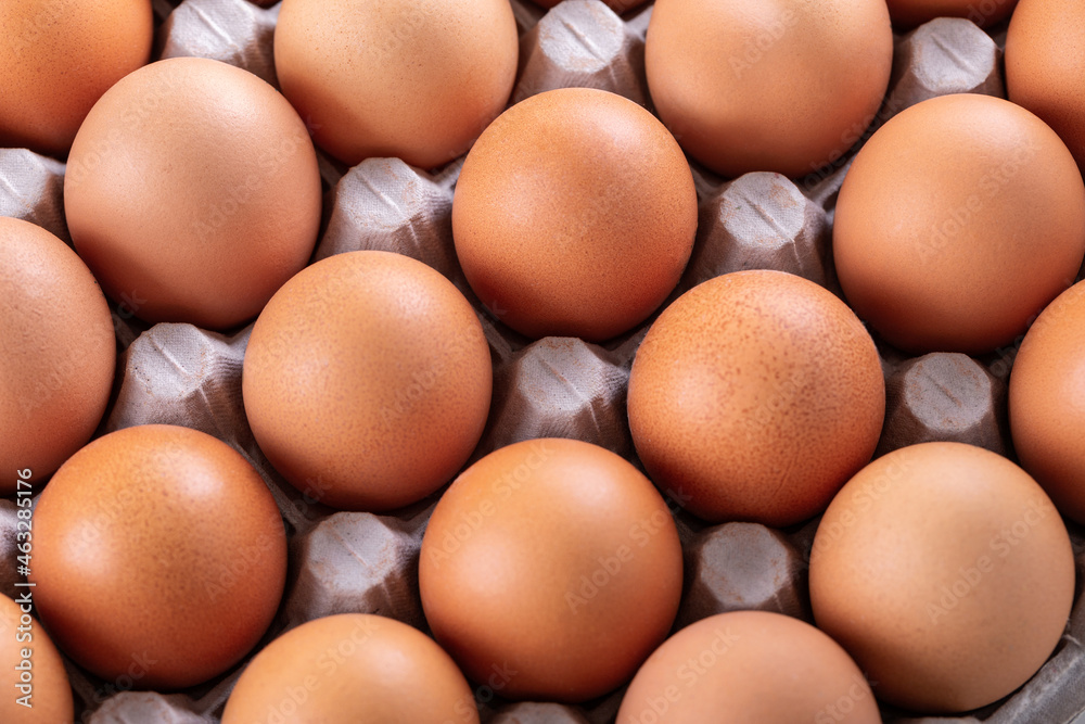 Fresh eggs in box, closeup on white background Fresh eggs in box, closeup on white background