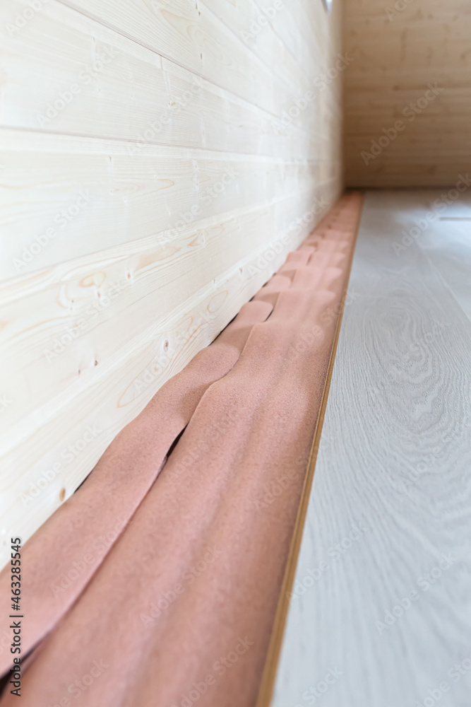 Installation of floating laminate inside room. closeup Installation of floating laminate inside room. closeup