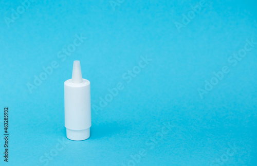 White different medical or cosmetic jars on a blue background as a concept of cosmetology of medecine and treatment