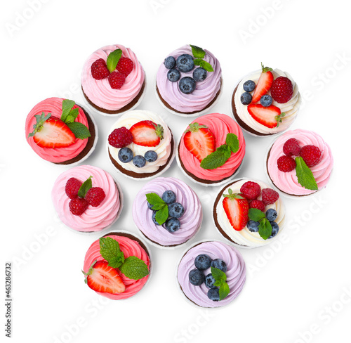 Fototapeta Naklejka Na Ścianę i Meble -  Sweet cupcakes with fresh berries on white background, top view