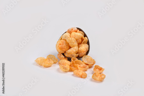 Fried and Spicy Moon Cup, Vatka, Katori, Moon Chips, Snacks or Fryums (Snacks Pellets) served in a bowl or White background. selective focus - Image
