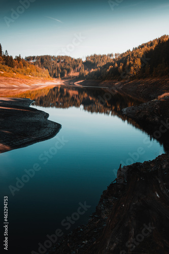 Calm  relaxed and peaceful mountain lake on a early morning with sunrise colors and blue water. Beautiful natural mountain lake  Harz Mountains  Germany