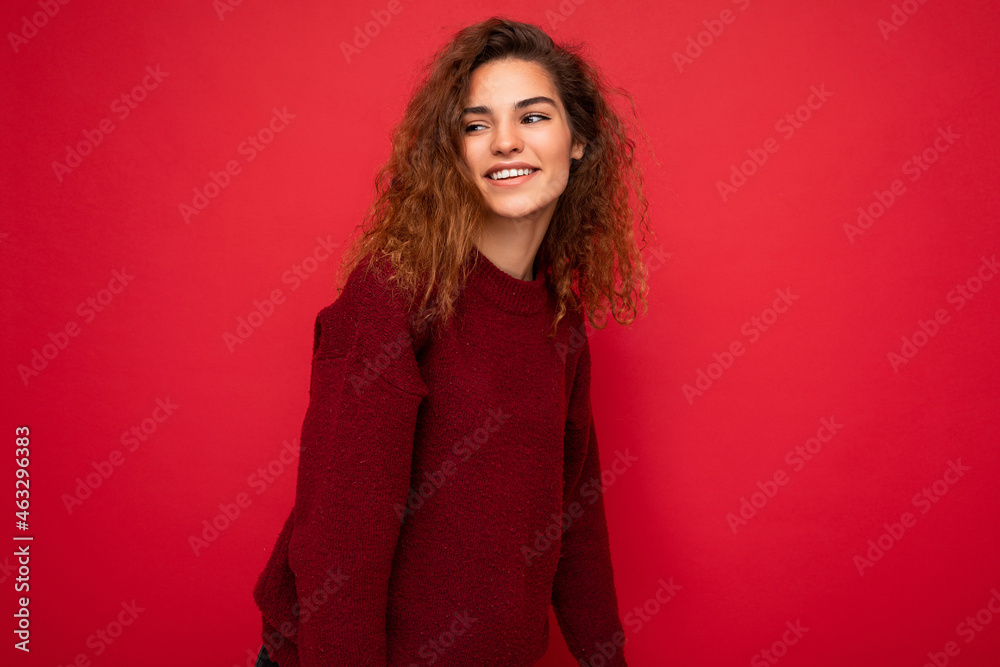Shot of attractive happy smiling young woman wearing casual outfit standing isolated over colourful background with empty space looking to the side Shot of attractive happy smiling young woman wearing casual outfit standing isolated over colourful background with empty space looking to the side