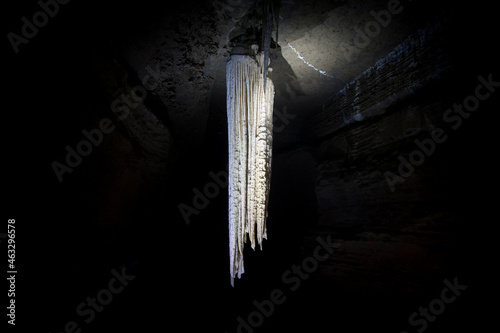 illuminated large stalactite in doolin cave in ireland
