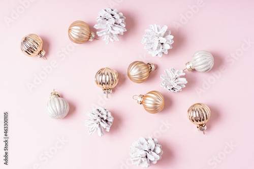 White cones and small Christmas balls on pink background. Happy New Year and Christmas celebration