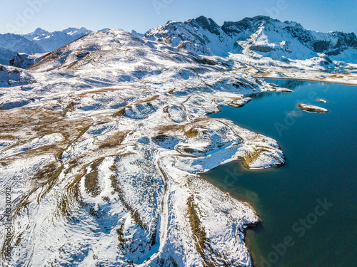 The aerial image of the first snow falls on the Tannensee Lake in the recreation area Melchsee-Frutt photo
