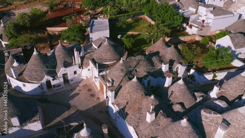 Aerial view of trulli of alberobello town in Italy. drone fly over old town buildings at sunrise
